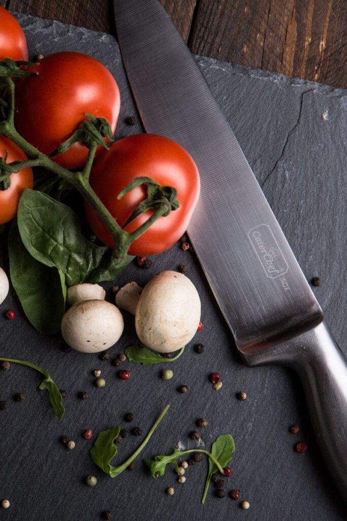 picture of chefs knife and tomatoes