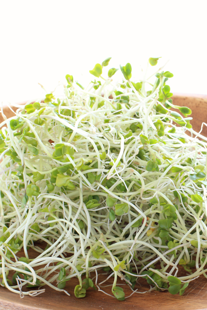 Broccoli sprouts on wood tray